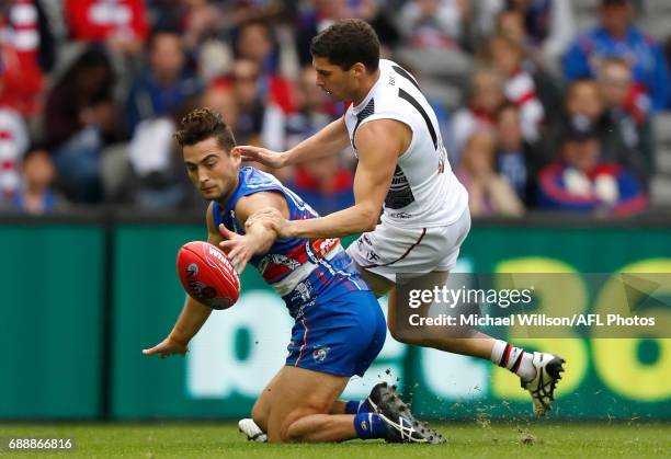 Luke Dahlhaus of the Bulldogs and Leigh Montagna of the Saints compete for the ball during the 2017 AFL round 10 match between the Western Bulldogs...