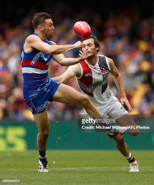 Matthew Suckling of the Bulldogs and Dylan Roberton of the Saints in action during the 2017 AFL round 10 match between the Western Bulldogs and the...