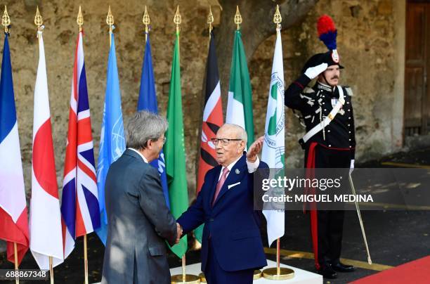 Italian Prime Minister Paolo Gentiloni welcomes Tunisian President Beji Caid Essebsi as he arrives at the Hotel San Domenico on the second day of the...