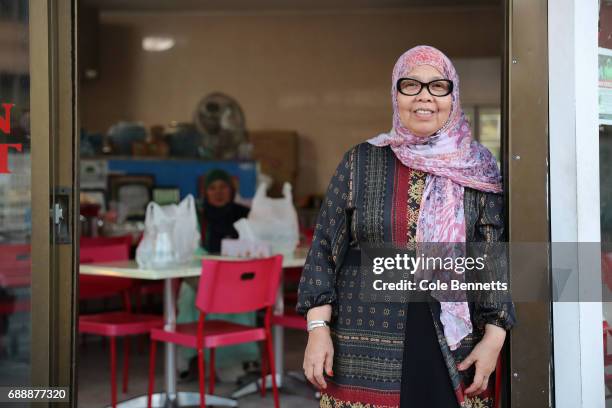 Woman poses for a photograph at the front of her restaurant in the south-western suburb of Lakemba, on May 27, 2017 in Sydney, Australia. Muslims...