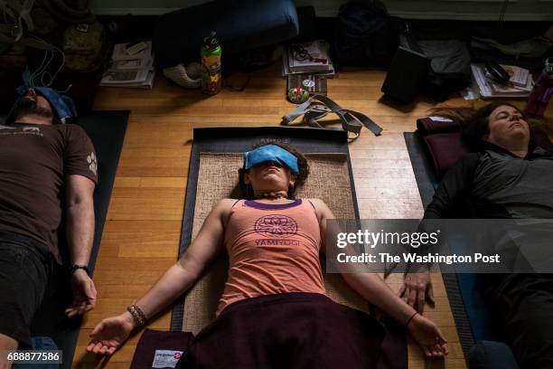 Participants in the VEToga teacher training perform Savasana on May 25, 2017 in Alexandria, Virginia.