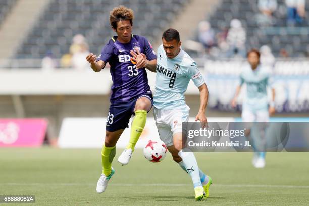 Tsukasa Shiotani of Sanfrecce Hiroshima and Fozil Musaev of Jubilo Iwata compete for the ball during the J.League J1 match between Sanfrecce...