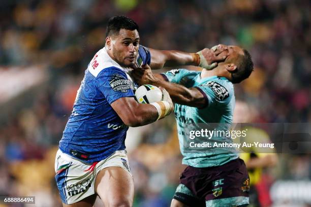 Sam Lisone of the Warriors fends off Benji Marshall of the Broncos during the round 12 NRL match between the New Zealand Warriors and the Brisbane...