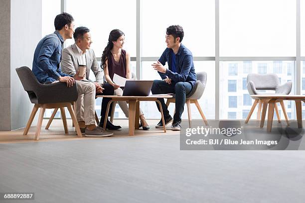 business people talking in meeting with a laptop - round table stockfoto's en -beelden