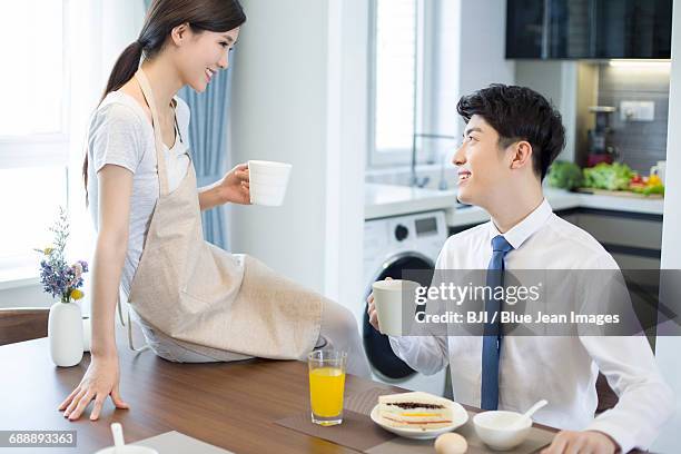 happy young couple having breakfast at home - シャツとネクタイ ストックフォトと画像