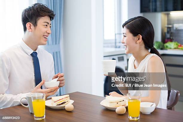 happy young couple having breakfast at home - シャツとネクタイ ストックフォトと画像