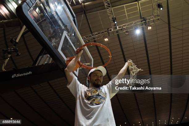 Yuta Tabuse of the Tochigi Brex cuts down the net after defeating the Kawasaki Brave Thunders in the the B. League final match between Kawasaki Brave...