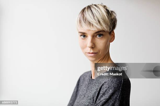 portrait of confident mid adult woman against white background - woman 30s stock pictures, royalty-free photos & images