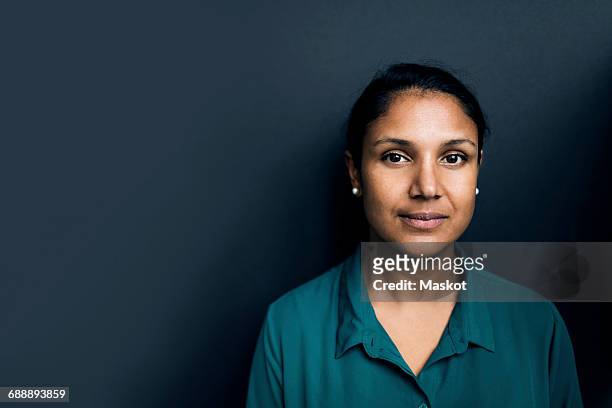 portrait of confident woman against gray background - formal portrait serious stock pictures, royalty-free photos & images