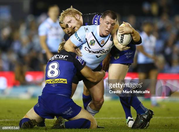 Paul Gallen of the Sharks is tackled by James Graham and Aiden Tolman of the Bulldogs during the round 12 NRL match between the Cronulla Sharks and...