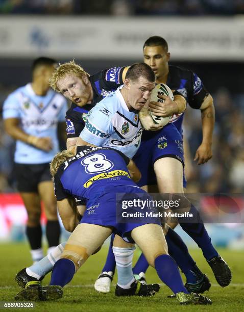 Paul Gallen of the Sharks is tackled by James Graham and Aiden Tolman of the Bulldogs during the round 12 NRL match between the Cronulla Sharks and...