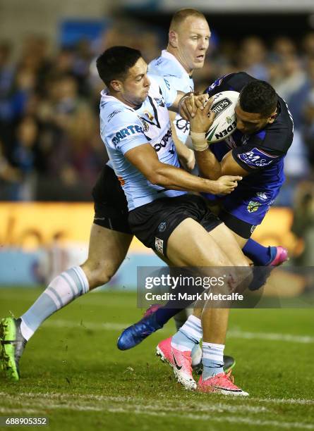 Gerard Beale of the Sharks tackles Marcelo Montoya of the Bulldogs during the round 12 NRL match between the Cronulla Sharks and the Canterbury...