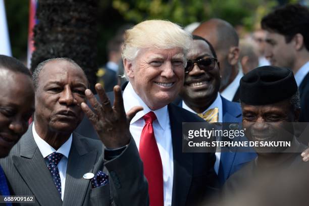 President Donald Trump shares a laugh with Guinea's President Alpha Conde , the Vice President of Nigeria Yemi Osinbajo and other African leaders as...