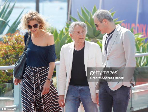 Writer Delphine de Vigan, Director Roman Polanski and Screenwriter Olivier Assayas attend the "Based On A True Story" photocall during the 70th...