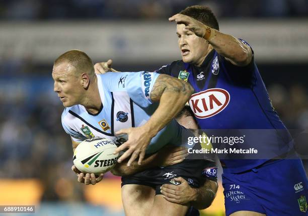 Luke Lewis of the Sharks is tackled by Greg Eastwood of the Bulldogs during the round 12 NRL match between the Cronulla Sharks and the Canterbury...