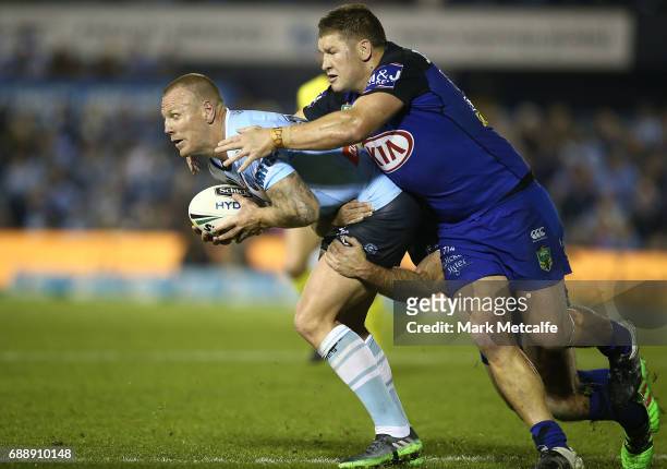 Luke Lewis of the Sharks is tackled by Greg Eastwood of the Bulldogs during the round 12 NRL match between the Cronulla Sharks and the Canterbury...