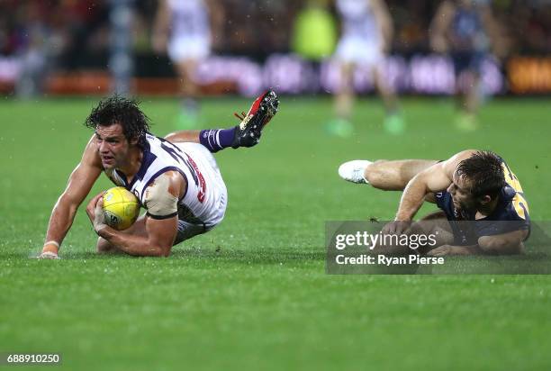 Brady Grey of the Dockers is tackled by Richard Douglas of the Crows during the round 10 AFL match between the Adelaide Crows and the Fremantle...