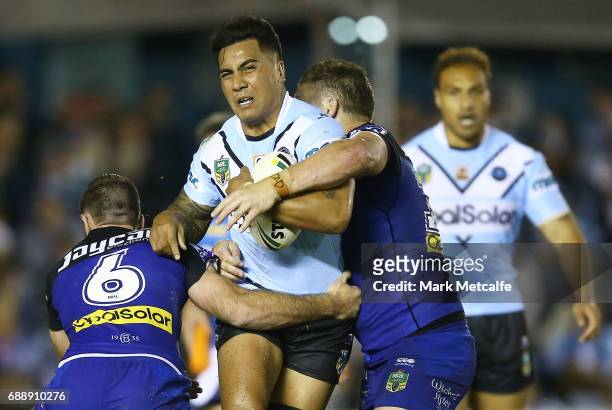 Sosaia Feki of the Sharks is tackled by Greg Eastwood and Matt Frawley of the Bulldogs during the round 12 NRL match between the Cronulla Sharks and...