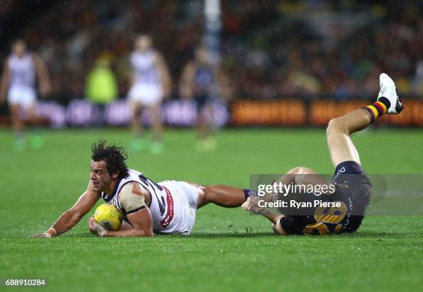 Brady Grey of the Dockers is tackled by Richard Douglas of the Crows during the round 10 AFL match between the Adelaide Crows and the Fremantle...