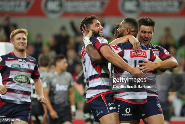 Marika Koroibete of the Rebels is congratulated by his Nic Stirzaker and Colby Fainga'a after scoring a try during the round 14 Super Rugby match...
