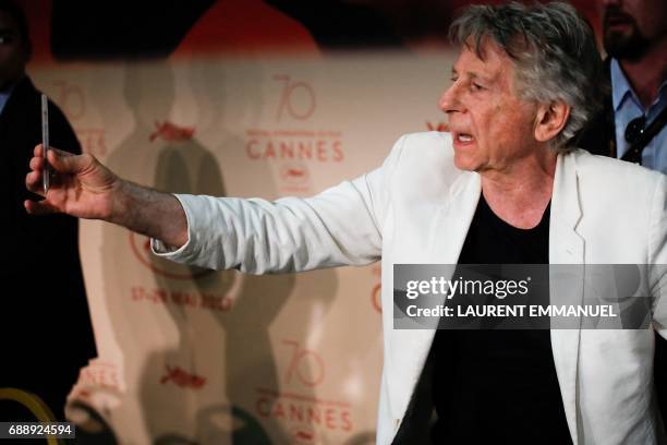 French-Polish director Roman Polanski signs autographs on May 27, 2017 after attending a press conference for the film 'Based on a True Story' at the...
