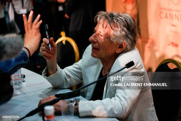 French-Polish director Roman Polanski signs autographs on May 27, 2017 after attending a press conference for the film 'Based on a True Story' at the...
