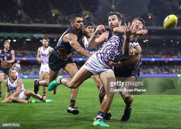 Lachie Weller of the Dockers is tackled by Andy Otten of the Crows during the round 10 AFL match between the Adelaide Crows and the Fremantle Dockers...