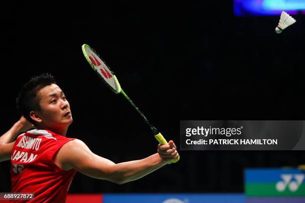 Kenta Nishimoto of Japan hits a return during the men's singles Sudirman Cup match against China's Lin Dan at the Gold Coast Sports Centre on May 27,...