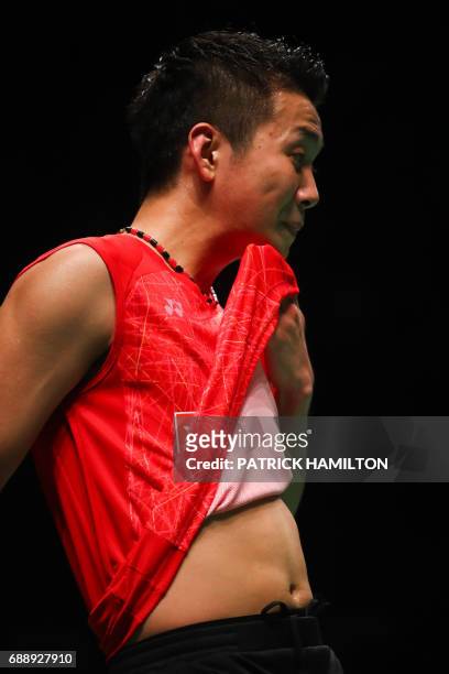 Kenta Nishimoto of Japan gestures during the men's singles Sudirman Cup match against China's Lin Dan at the Gold Coast Sports Centre on May 27,...