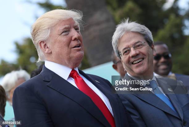 President Donald Trump and Italian Prime Minister Paolo Gentiloni chat during the group photo for the G7 Outreach Program on the second and last day...