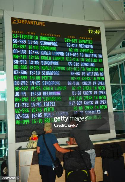 airport arrival departure board - jayk7 bali stock pictures, royalty-free photos & images