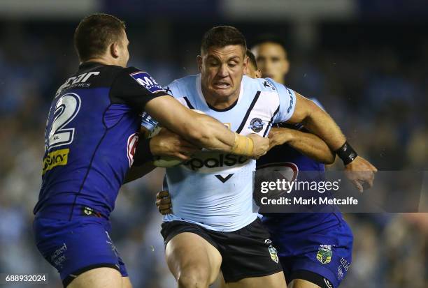 Chris Heighington of the Sharks is tackled during the round 12 NRL match between the Cronulla Sharks and the Canterbury Bulldogs at Southern Cross...