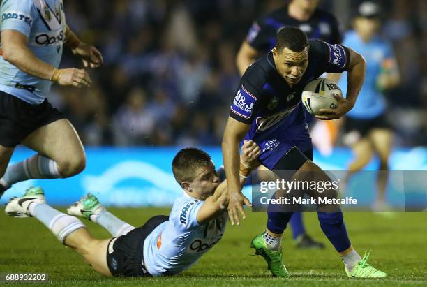 Moses Mbye of the Bulldogs is tackled by Jayden Brailey of the Sharks during the round 12 NRL match between the Cronulla Sharks and the Canterbury...