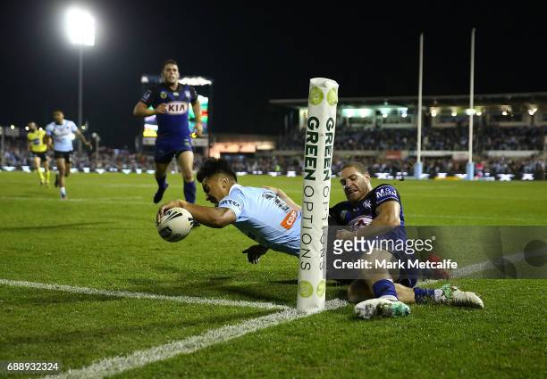 Sosaia Feki of the Sharks is tackled by Brenko Lee of the Bulldogs short of the try line during the round 12 NRL match between the Cronulla Sharks...