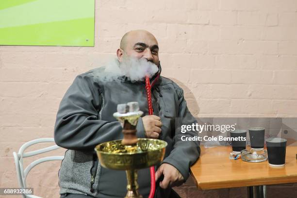 Man smokes a shisha during a street festival in the south-western suburb of Lakemba, on May 27, 2017 in Sydney, Australia. Muslims around the world...