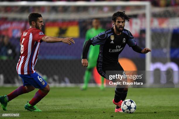Isco of Real Madrid and Koke of Atletico Madrid compete for the ball during the UEFA Champions League Semi Final second leg match between Club...
