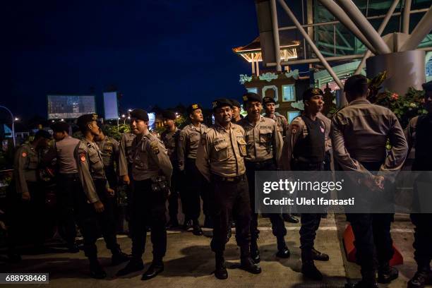 Indonesian police stand guard at the airport as they prepare for the deportation of Schapelle Corby from Indonesia on May 27, 2017 in Bali,...