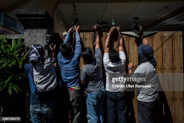 Journalists take pictures outside the villa where Schapelle Corby is living as she prepares for deportation from Indonesia on May 27, 2017 in Bali,...