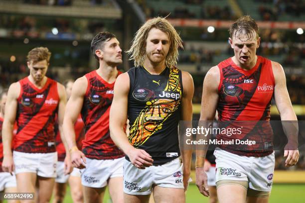 Dyson Heppell of the Bombers walks off wearing a Tigers jumper next to Brendon Goddard of the Bombers after defeat during the round 10 AFL match...