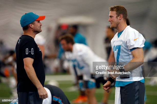 Ryan Tannehill talks to associate head coach / special teams coordinator Darren Rizzi of the Miami Dolphins during the teams OTA's on May 25, 2017 at...