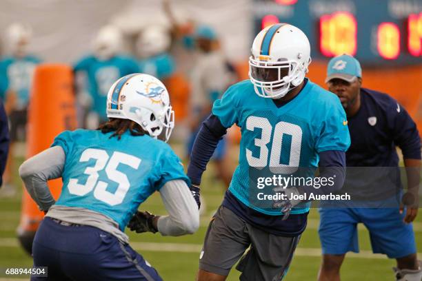 Walt Aikens runs a drill with Cordrea Tankersley of the Miami Dolphins during the teams OTA's on May 25, 2017 at the Miami Dolphins training facility...