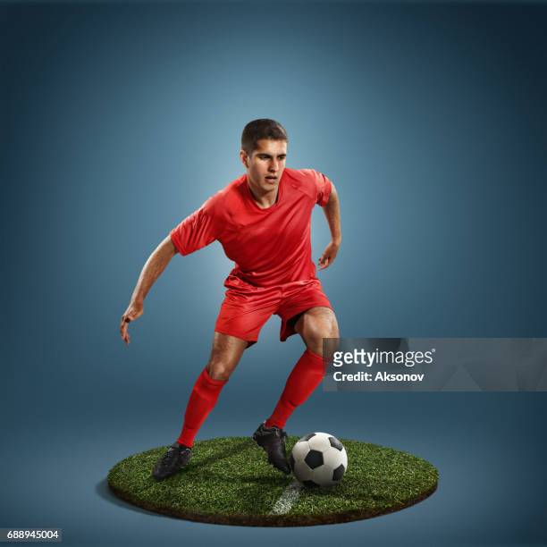 soccer player in action - football player stock pictures, royalty-free photos & images