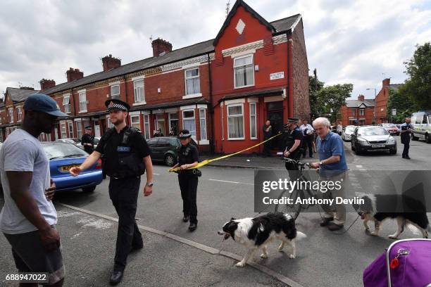 Police put up a corden as they attend the scene of a raid in the Moss Side area as part of their ongoing investigation following the terror attack...
