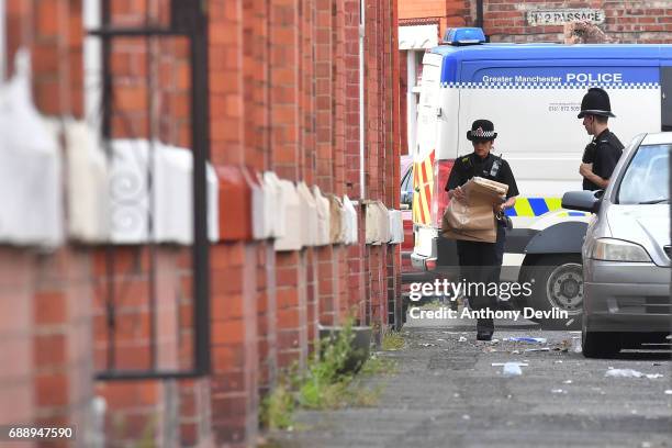 Police attend the scene of a raid in the Moss Side area as part of their ongoing investigation following the terror attack earlier this week on May...