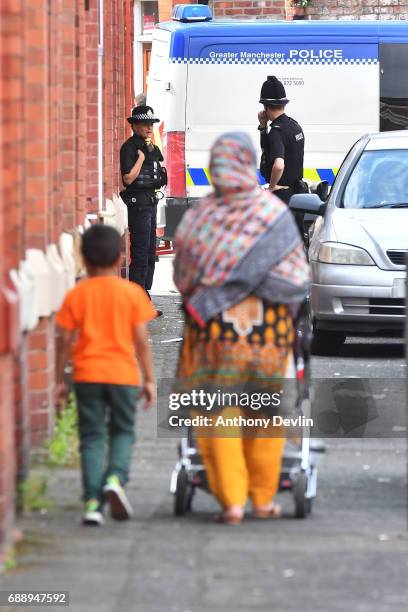 Police attend the scene of a raid in the Moss Side area as part of their ongoing investigation following the terror attack earlier this week on May...