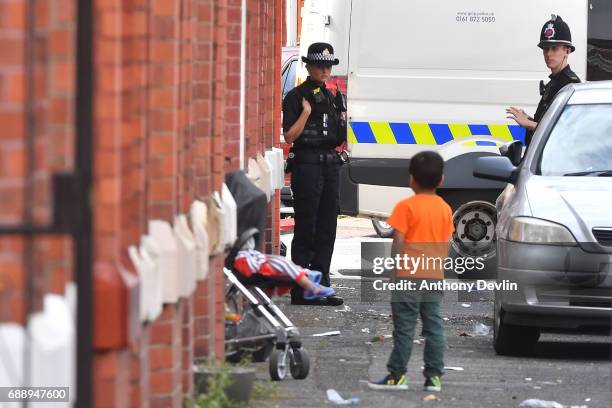 Police attend the scene of a raid in the Moss Side area as part of their ongoing investigation following the terror attack earlier this week on May...