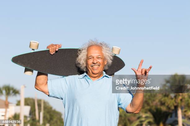 cool senior posing with a skateboard - men bulge imagens e fotografias de stock