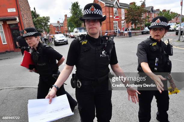 Police put up a corden as they attend the scene of a raid in the Moss Side area as part of their ongoing investigation following the terror attack...