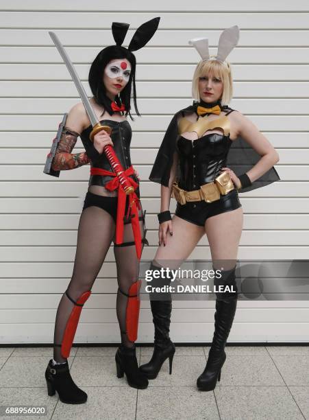Jadene as 'Katana' and Katie as 'Batgirl' from the ?DC cosplay bunnies, pose together for a photograph on the second day of the London "MCM Comic...