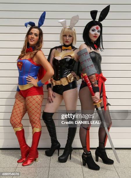 Rebecca as 'Supergirl', Katie as 'Batgirl' and Jadene as 'Katana' from the ?DC cosplay bunnies, pose together for a photograph on the second day of...